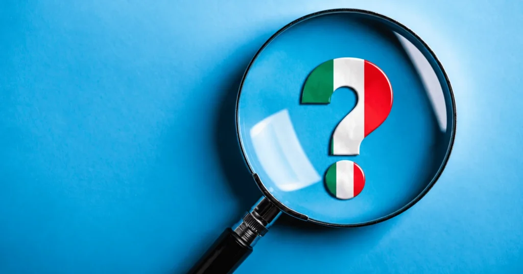 Lupa sobre un signo de pregunta con los colores de Italia: preguntas frecuentes sobre los hijos mayores